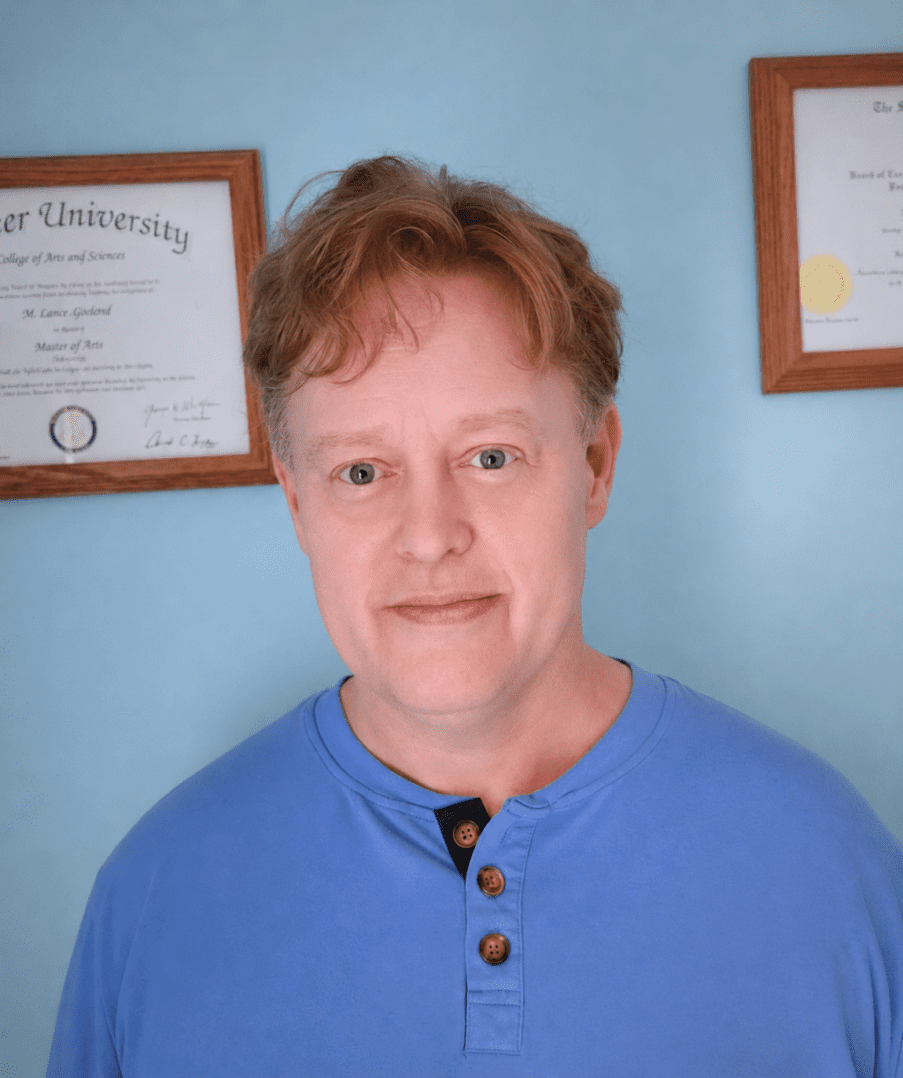 Lance head shot with diplomas